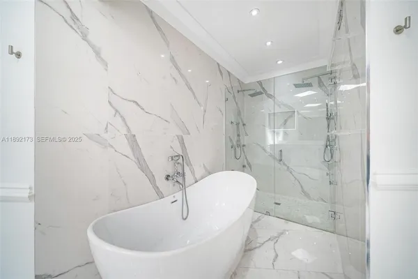 a spacious bathroom with a bathtub and shower