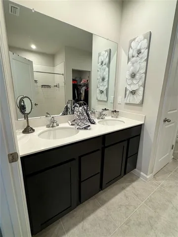 a bathroom with a double vanity sink mirror and double