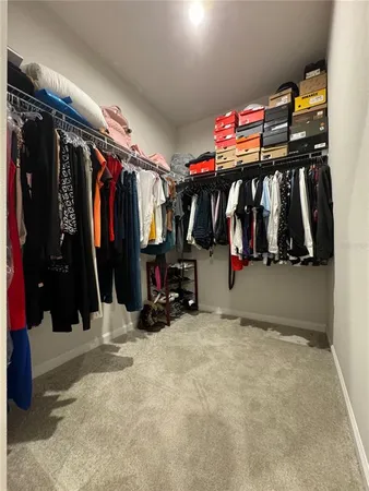 a view of walk in closet with clothes