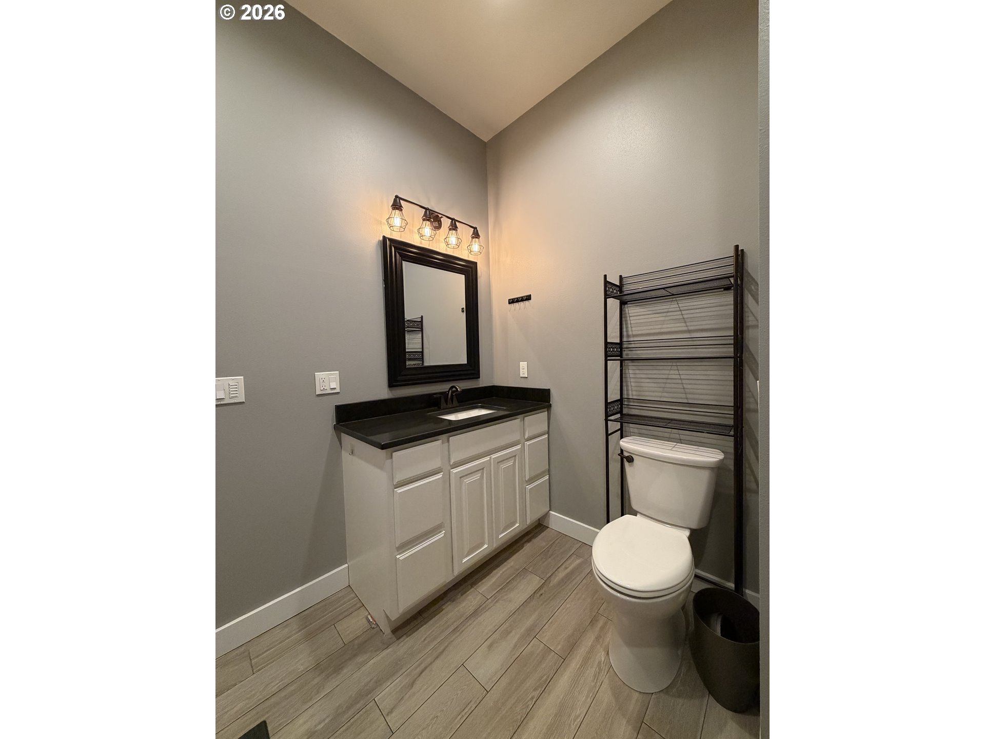 788 Patrick Street Coos Bay, OR 97420 - Photo 19 of 28 a bathroom with a toilet a sink and mirror