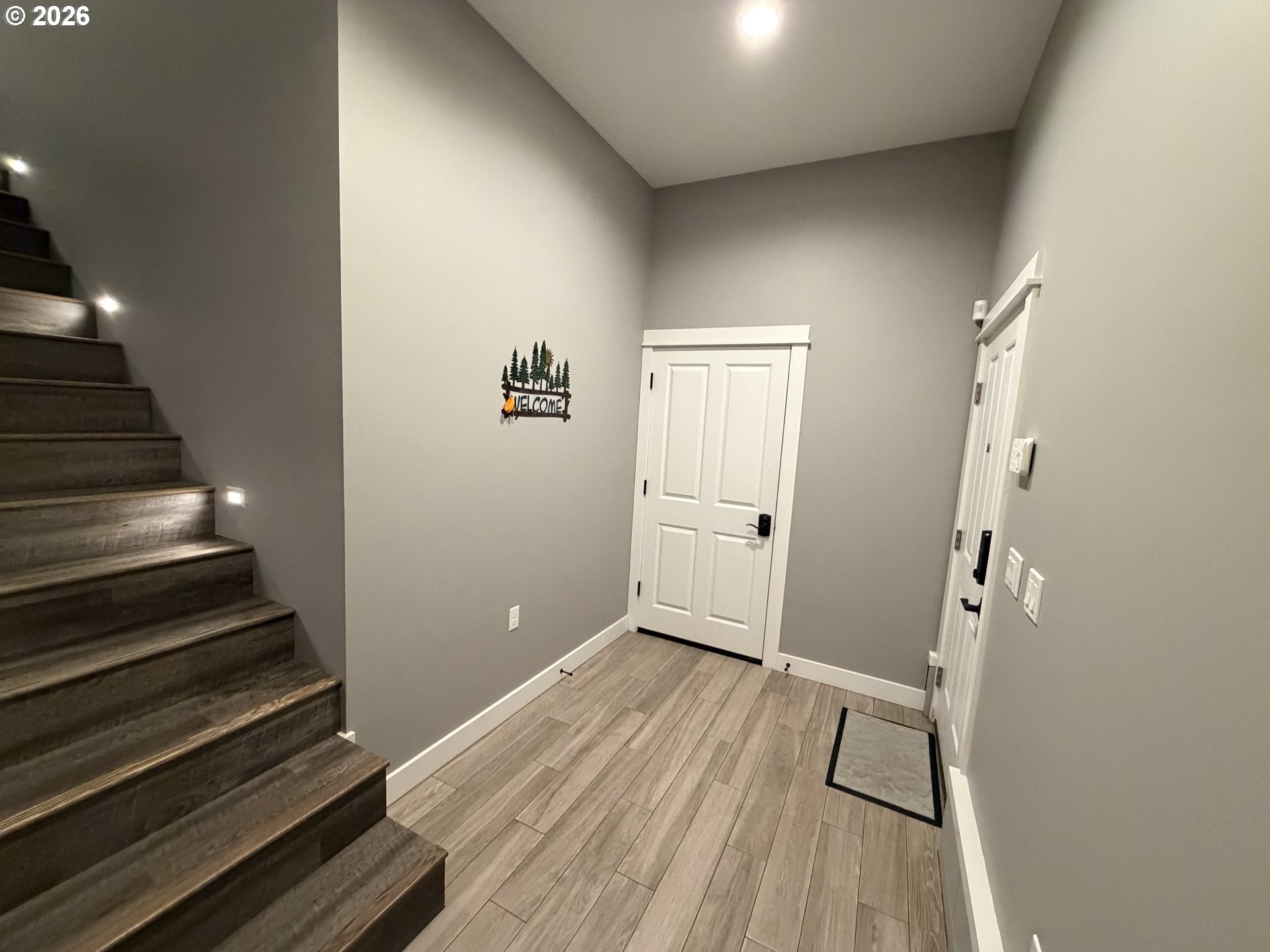 788 Patrick Street Coos Bay, OR 97420 - Photo 4 of 28 a view of a hallway with wooden floor and staircase