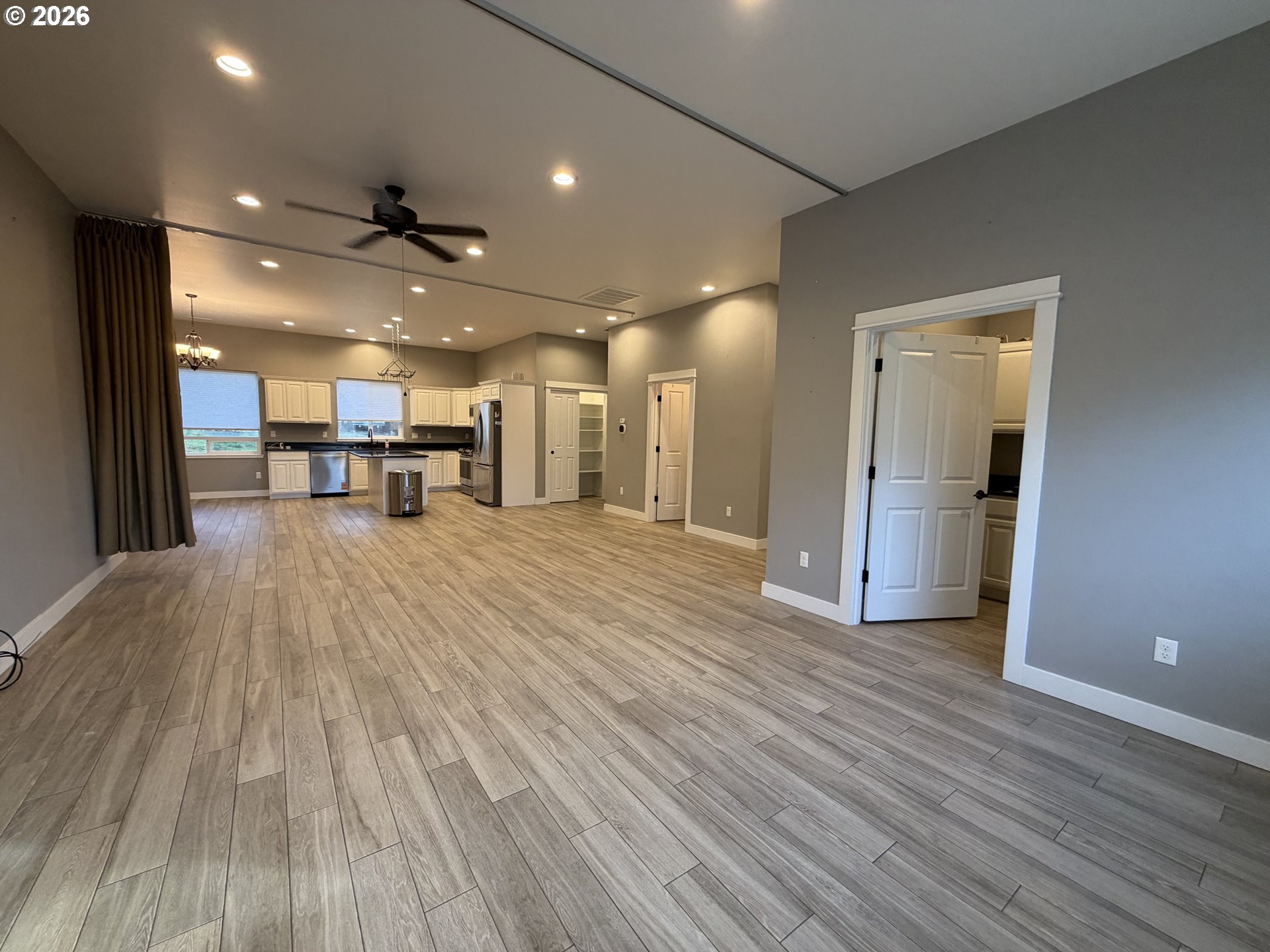 788 Patrick Street Coos Bay, OR 97420 - Photo 9 of 28 a view of a big room with wooden floor and a kitchen