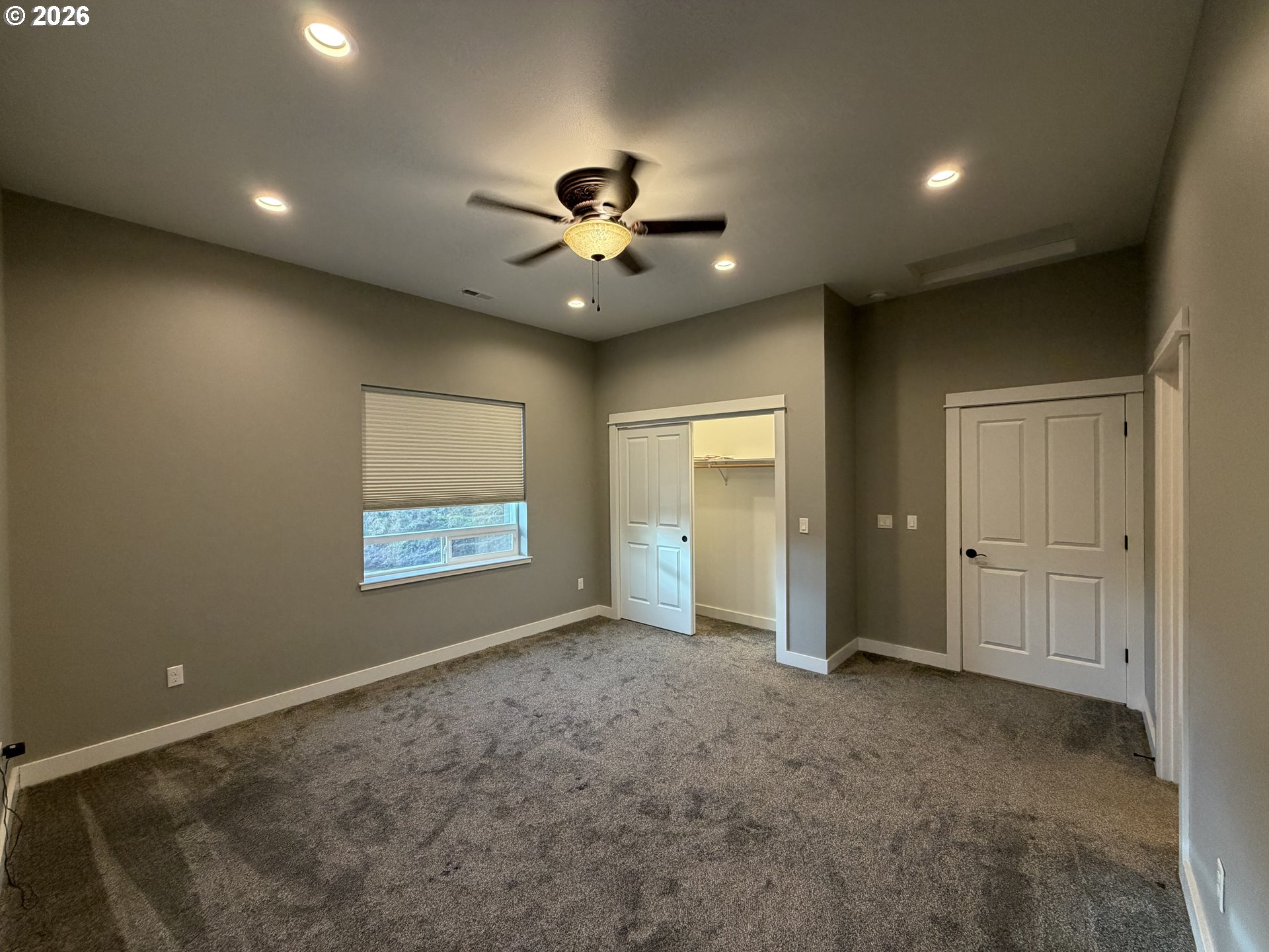 788 Patrick Street Coos Bay, OR 97420 - Photo 10 of 28 a view of an empty room and a ceiling fan window and a ceiling fan
