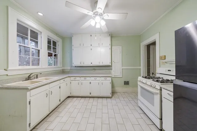 a kitchen with a sink stove and cabinets