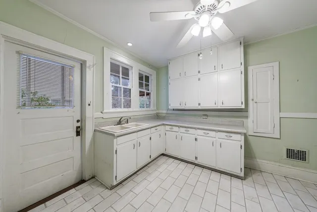 a kitchen with granite countertop white cabinets and white appliances