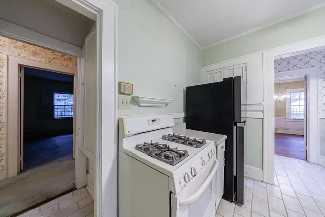 a kitchen with a stove a refrigerator and a oven