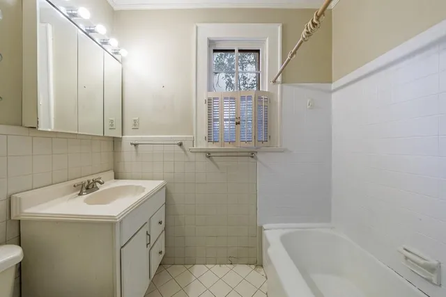 a bathroom with a sink mirror toilet and bathtub