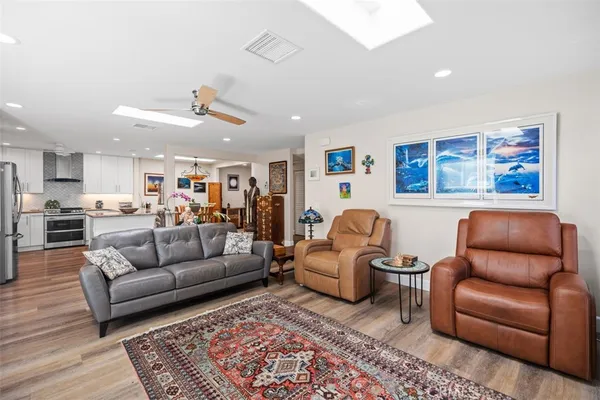 a living room with furniture and kitchen view