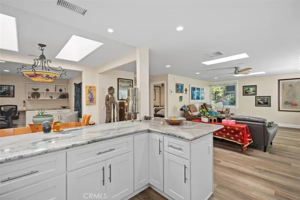 a kitchen with sink stove and wooden floor