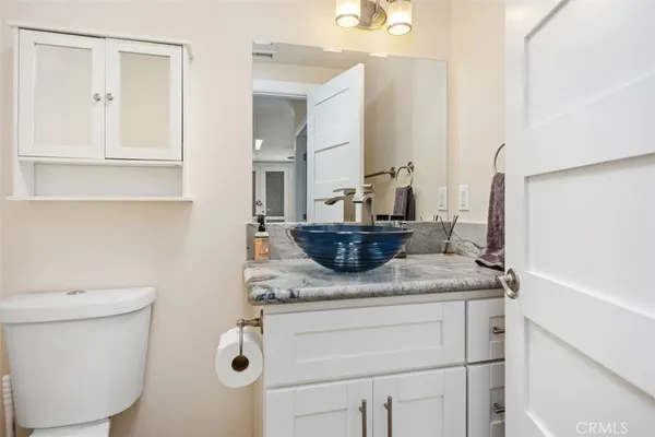 a bathroom with a sink toilet and mirror