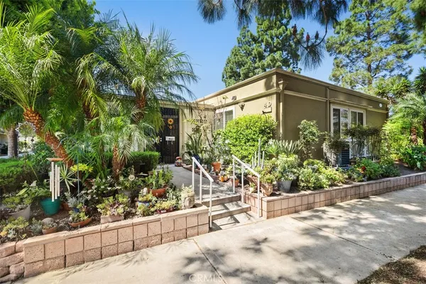 a view of a house with potted plants