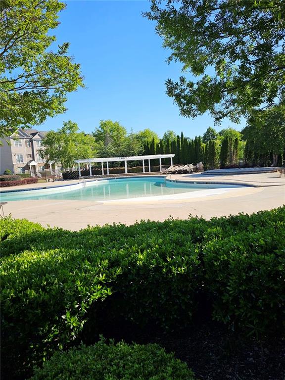 5747 Radford Loop Fairburn, GA 30213 - Photo 35 of 36 a view of a lake with lawn chairs and large trees