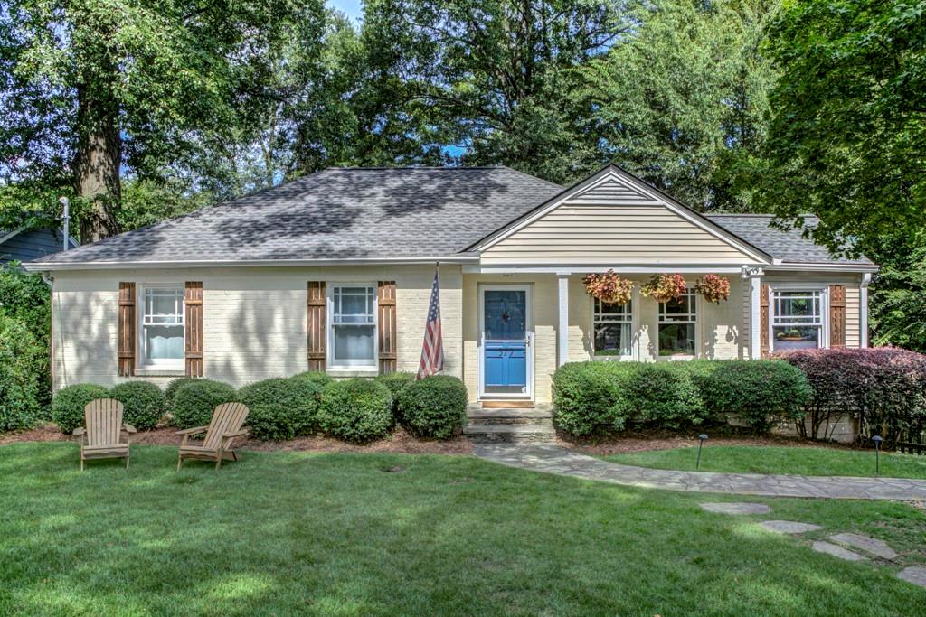 a front view of a house with a garden and porch