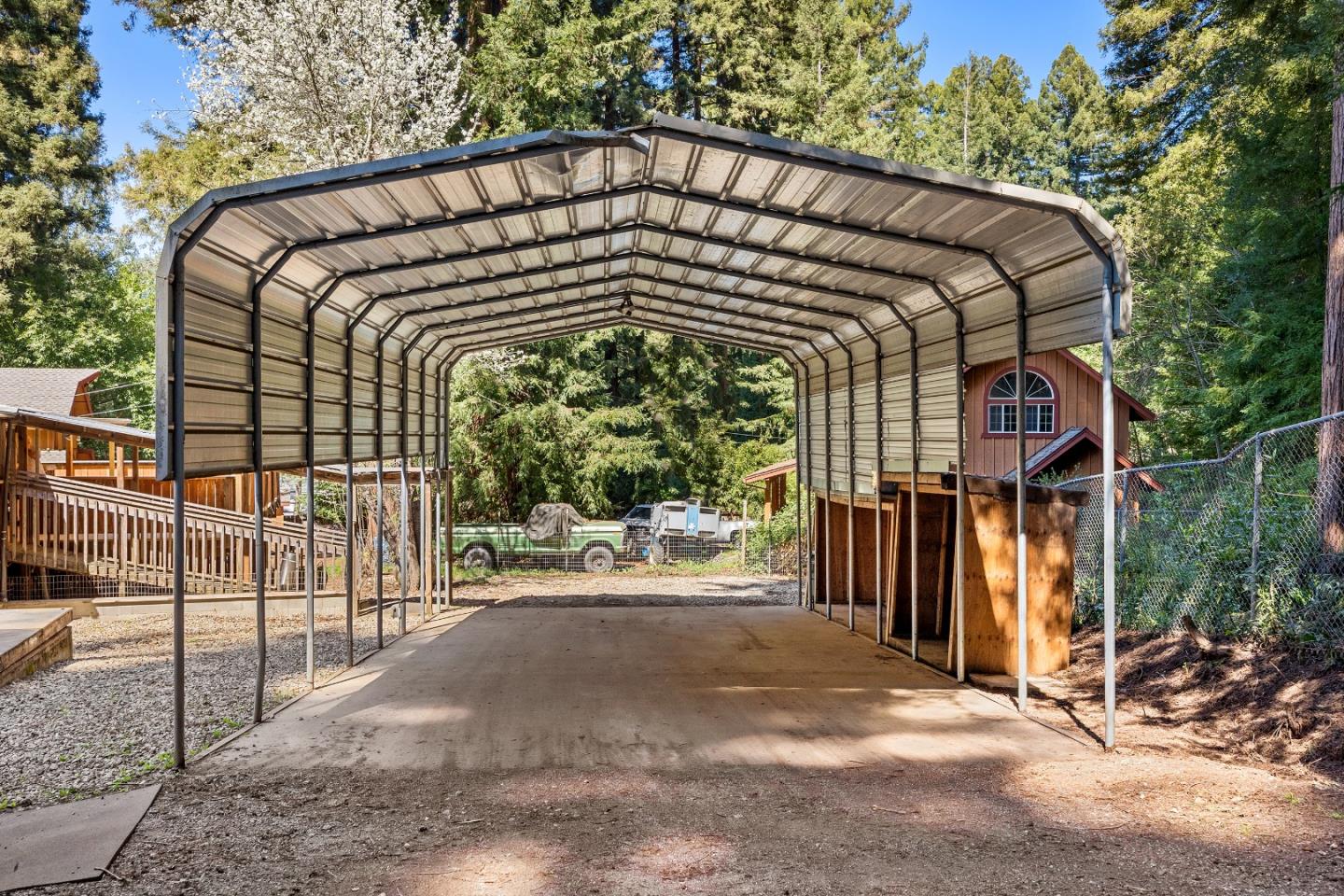 15666 Kings Creek Road Boulder Creek, CA 95006 - Photo 33 of 40 a view of a house with a small yard and wooden fence