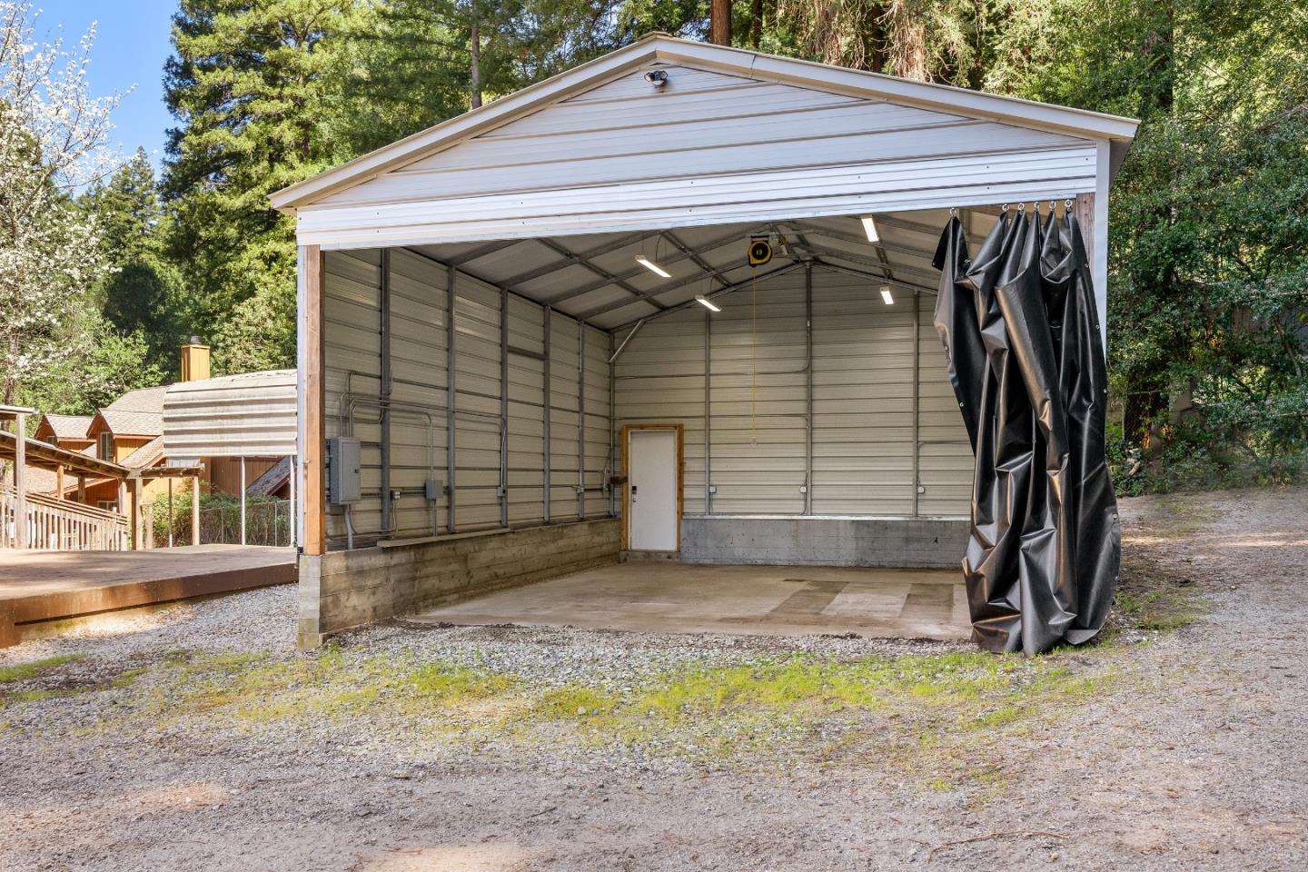 15666 Kings Creek Road Boulder Creek, CA 95006 - Photo 36 of 40 a view of a small house with a small yard and garage