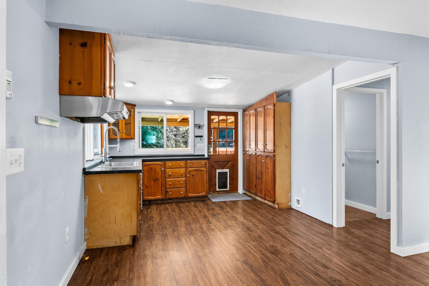 15666 Kings Creek Road Boulder Creek, CA 95006 - Photo 4 of 40 a kitchen with stainless steel appliances granite countertop wooden floors and sink