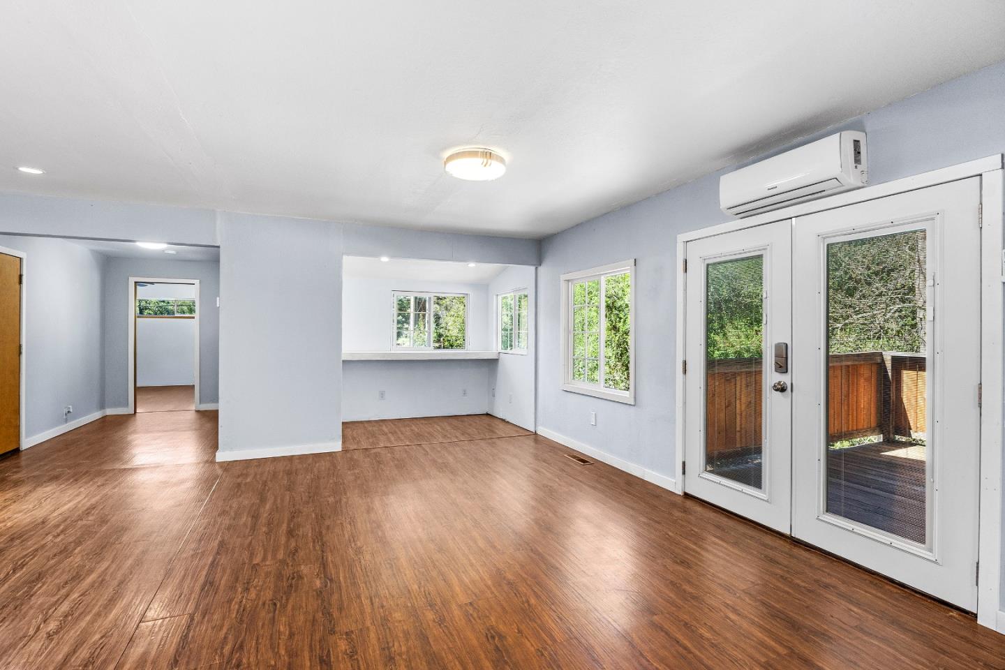 15666 Kings Creek Road Boulder Creek, CA 95006 - Photo 5 of 40 an empty room with wooden floor and windows