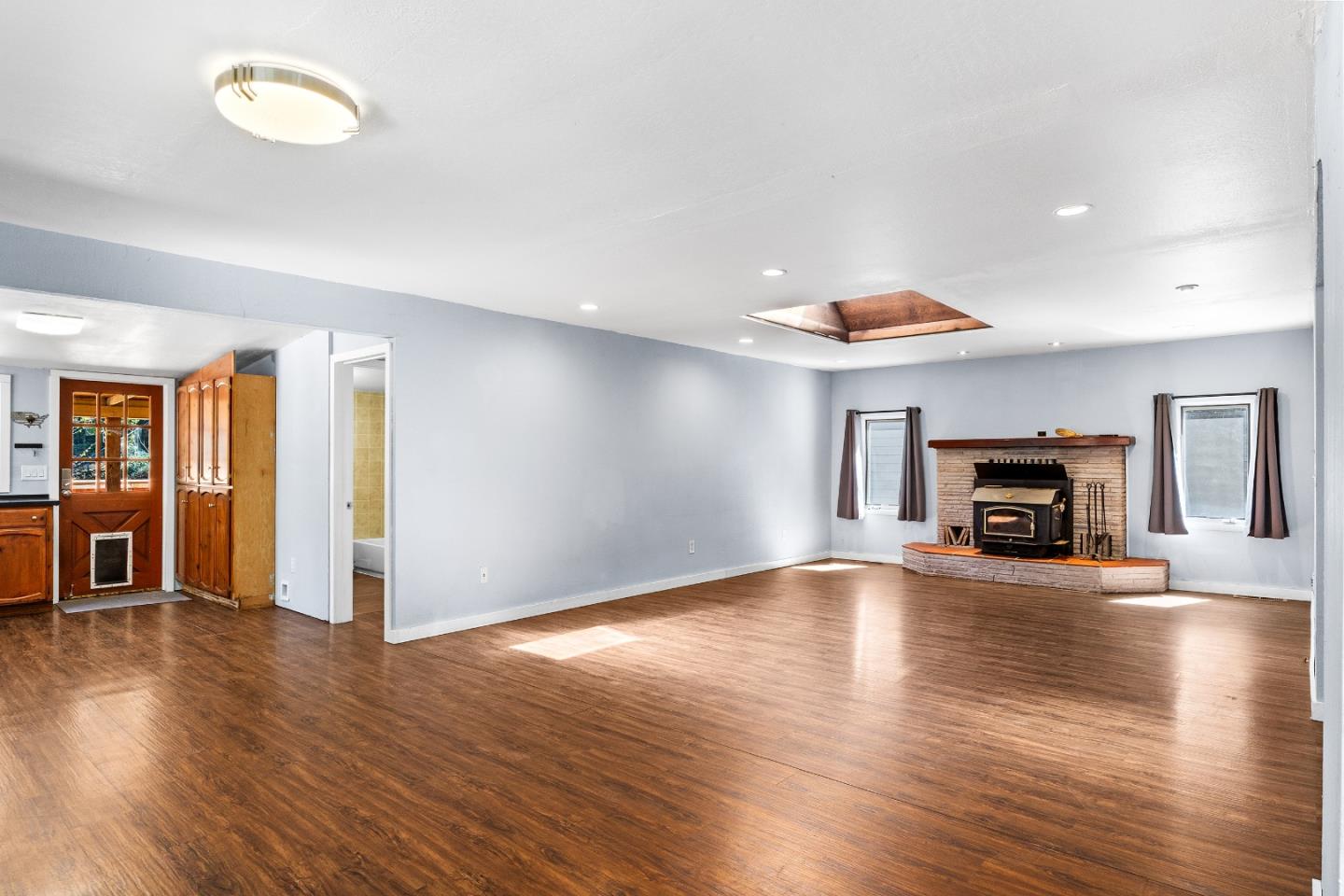 15666 Kings Creek Road Boulder Creek, CA 95006 - Photo 7 of 40 a view of empty room with wooden floor and fireplace