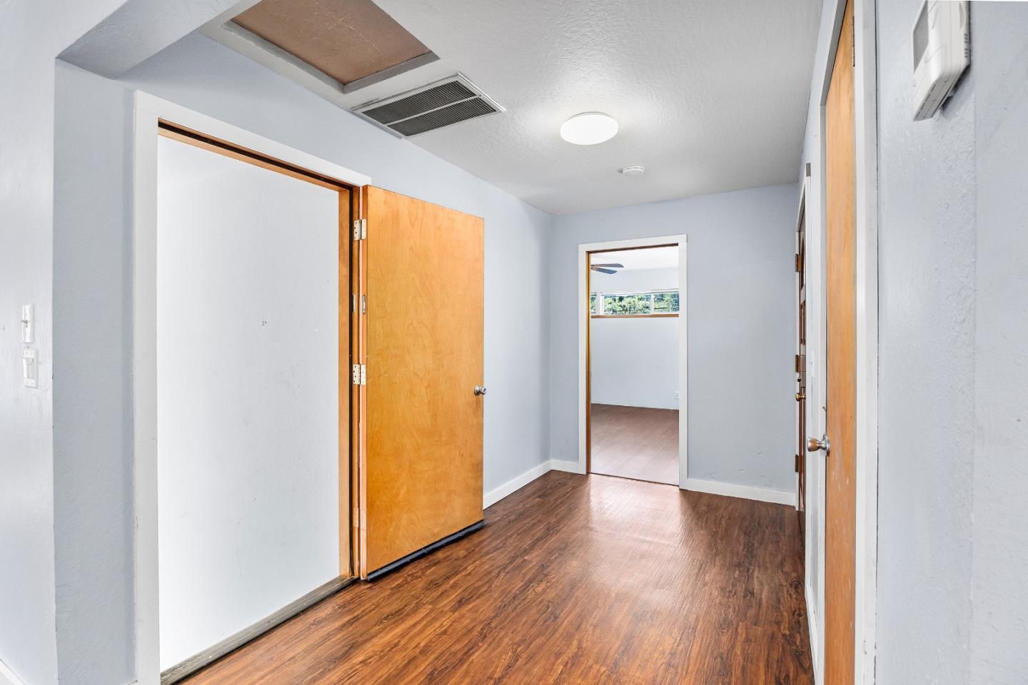 15666 Kings Creek Road Boulder Creek, CA 95006 - Photo 9 of 40 a view of an empty room with wooden floor and a window