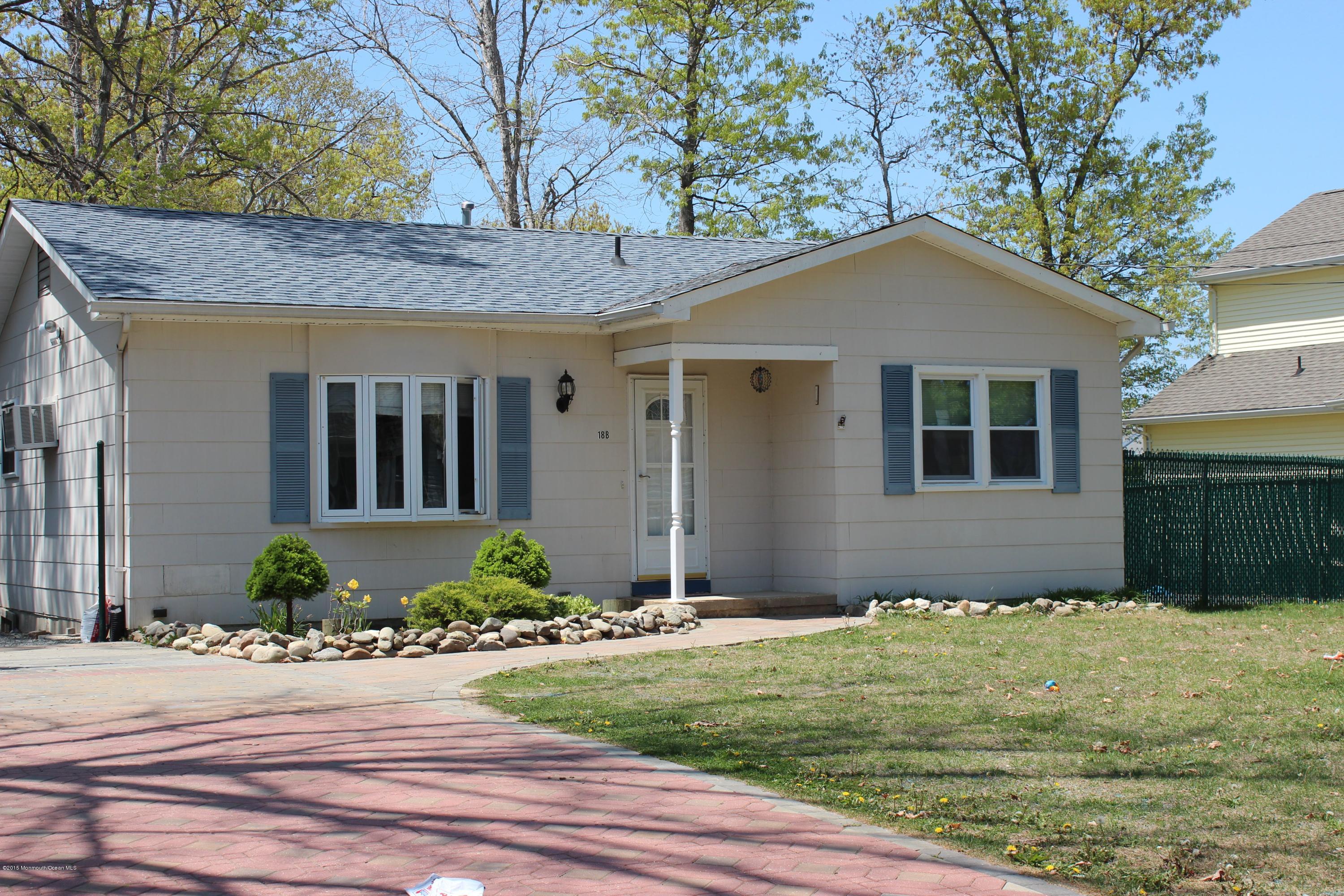 188 Stowaway Road Manahawkin, NJ 08050 - Photo 1 of 18 a front view of a house with garden