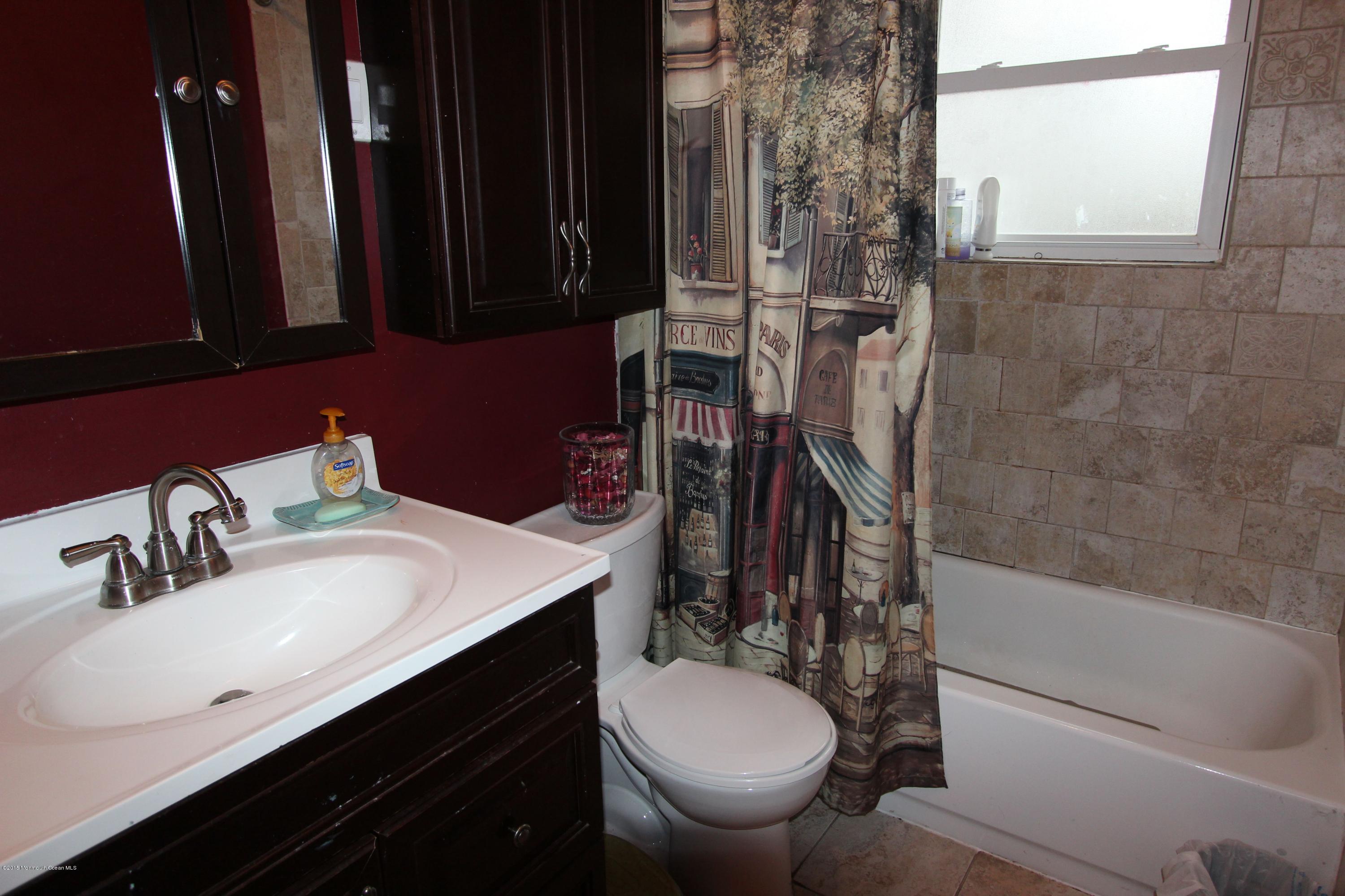 188 Stowaway Road Manahawkin, NJ 08050 - Photo 14 of 18 a bathroom with a sink and a mirror