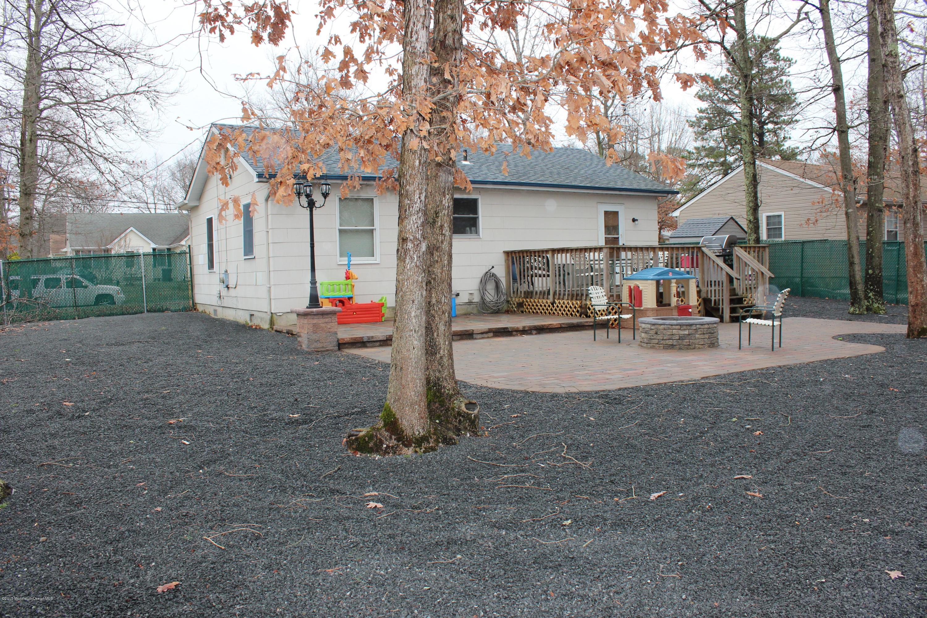 188 Stowaway Road Manahawkin, NJ 08050 - Photo 18 of 18 a view of a white house with a large tree and wooden fence