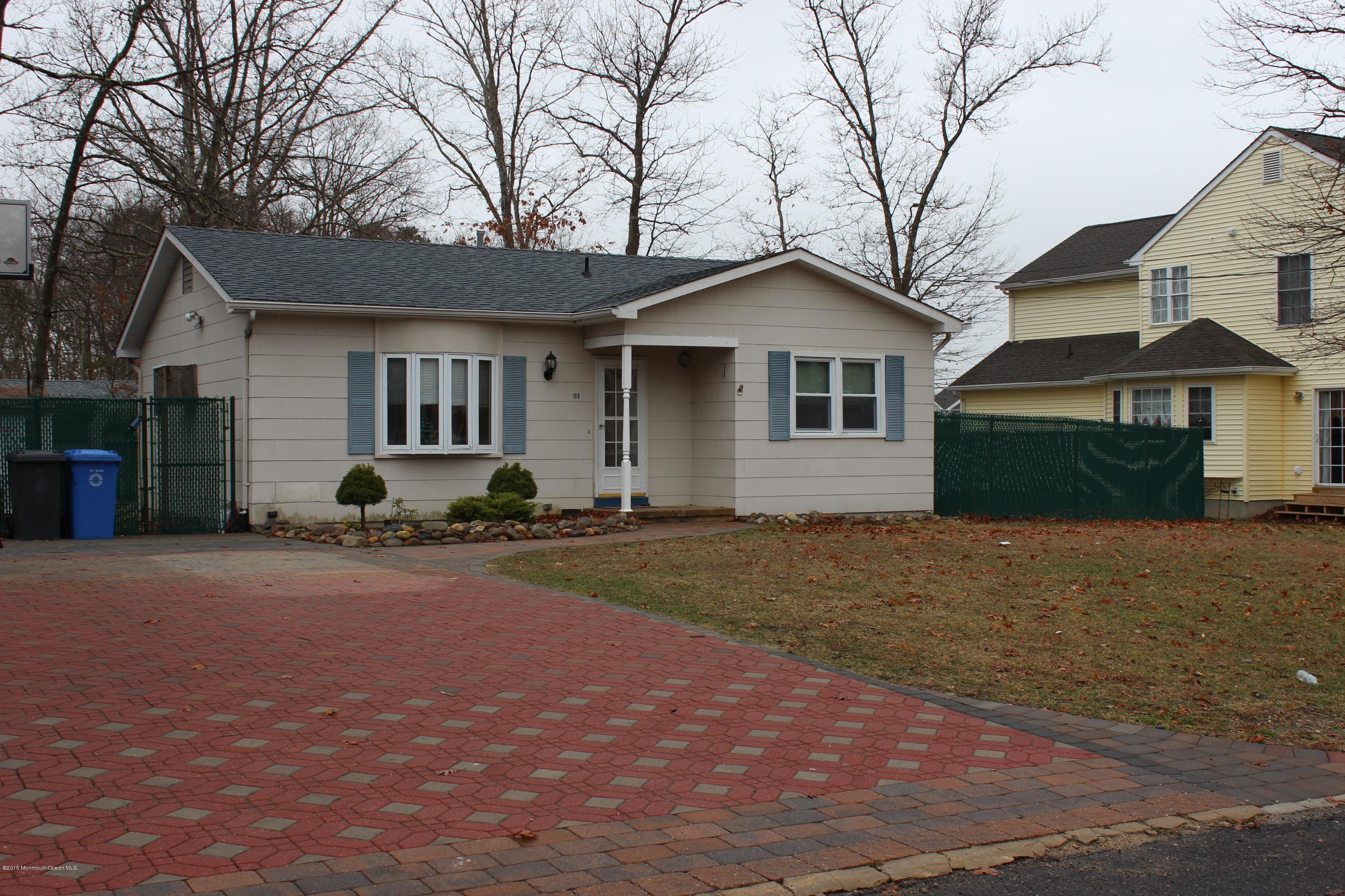 188 Stowaway Road Manahawkin, NJ 08050 - Photo 3 of 18 a front view of a house with a yard and garage