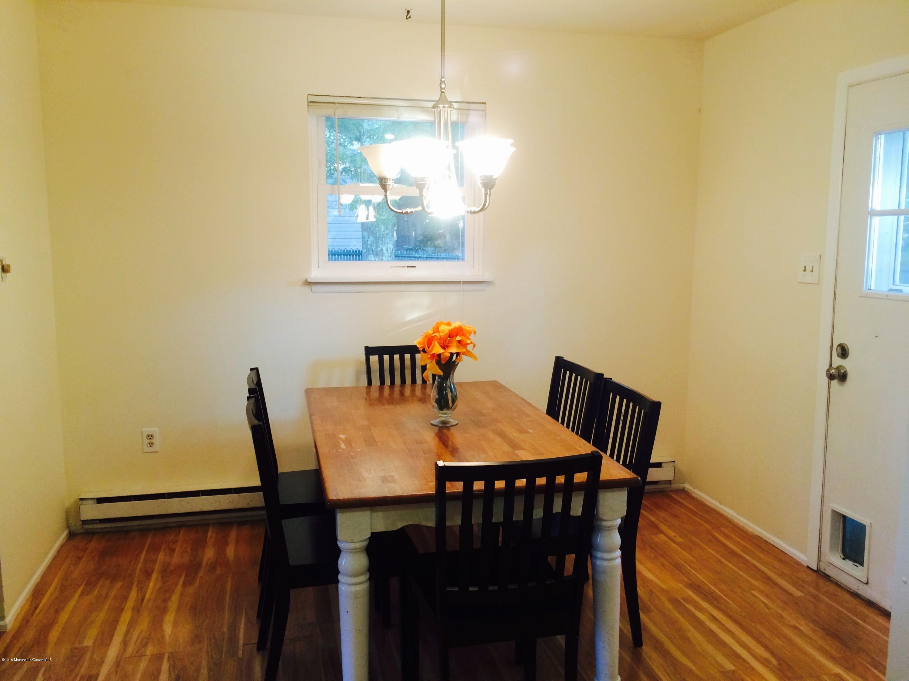 188 Stowaway Road Manahawkin, NJ 08050 - Photo 4 of 18 a view of a dining room with furniture and wooden floor