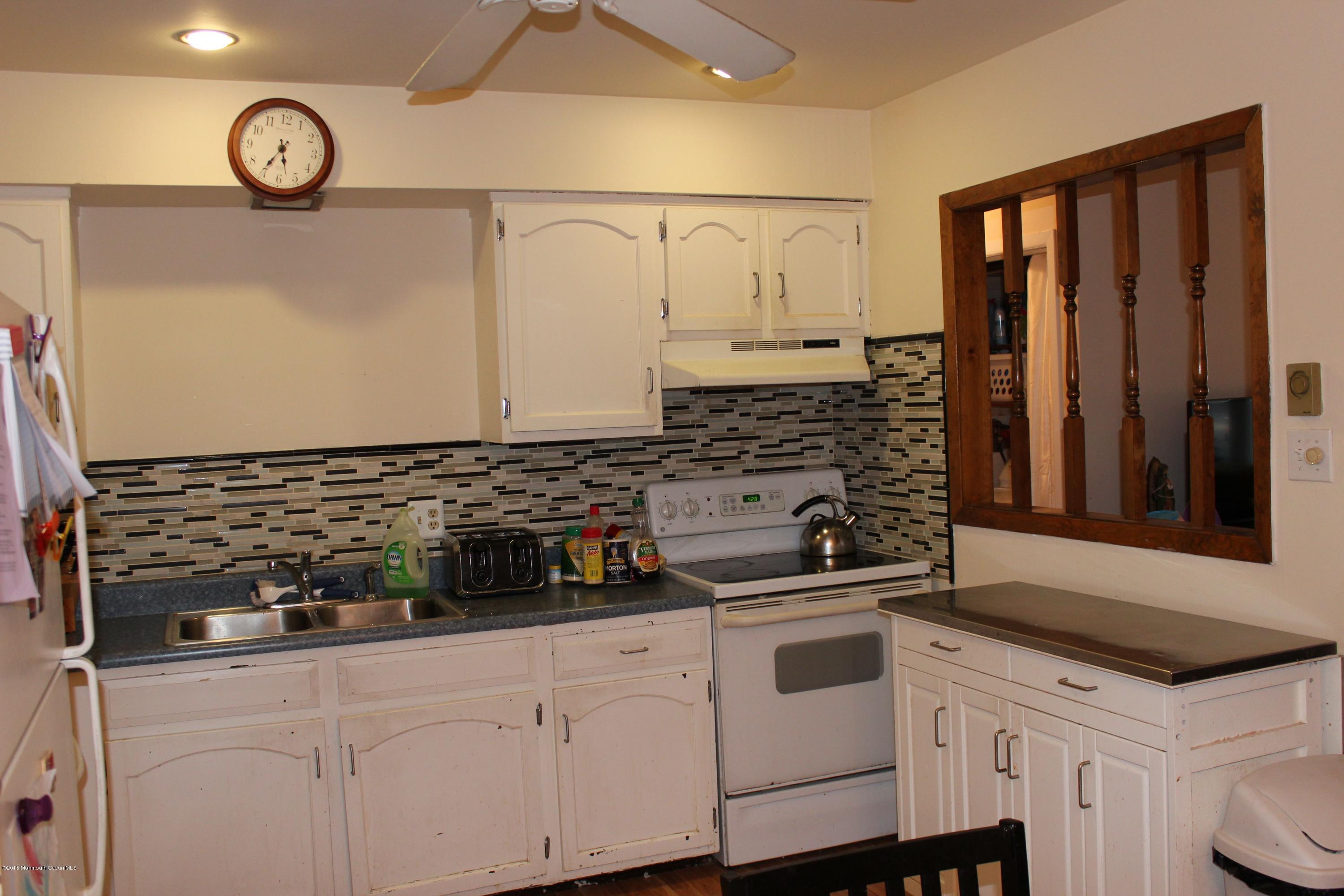 188 Stowaway Road Manahawkin, NJ 08050 - Photo 7 of 18 a kitchen with stainless steel appliances granite countertop a sink and cabinets
