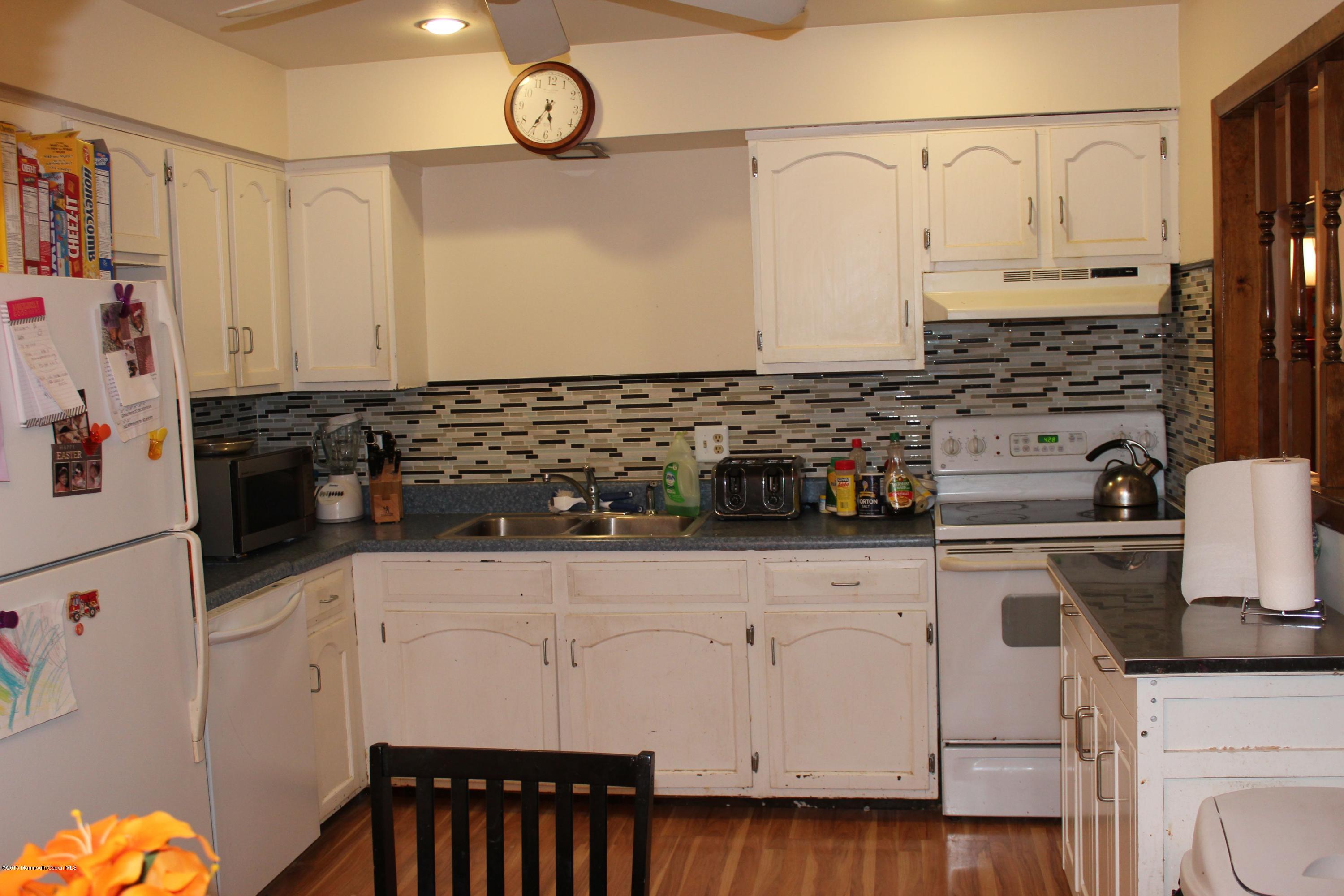 188 Stowaway Road Manahawkin, NJ 08050 - Photo 8 of 18 a kitchen with stainless steel appliances a stove a refrigerator a sink and cabinets