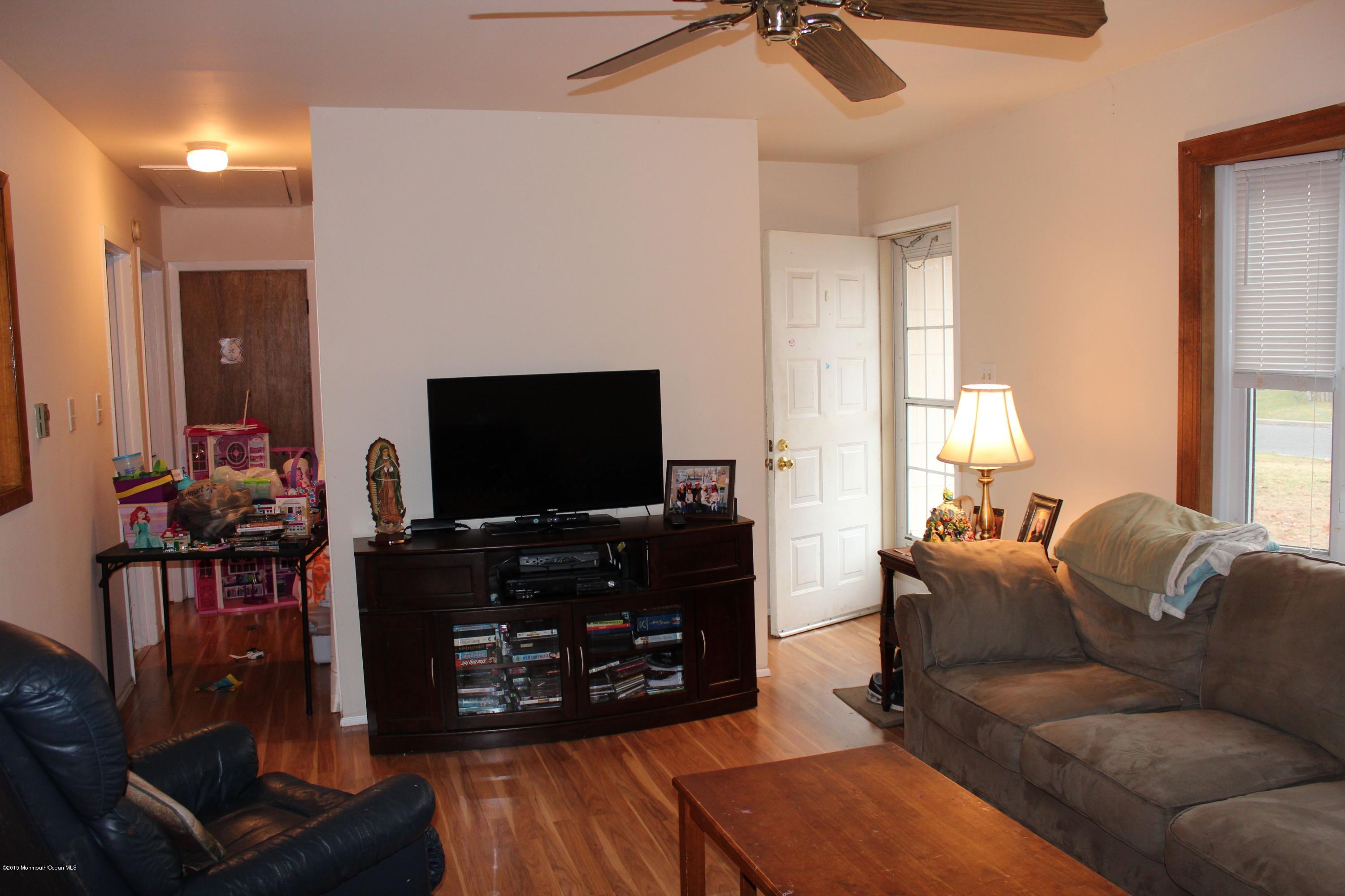 188 Stowaway Road Manahawkin, NJ 08050 - Photo 10 of 18 a living room with furniture and a flat screen tv
