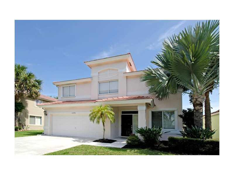 10096 Country Brook Road Boca Raton, FL 33428 - Photo 1 of 29 a front view of a house with a yard