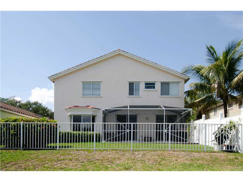 10096 Country Brook Road Boca Raton, FL 33428 - Photo 17 of 29 a front view of a house with a garden