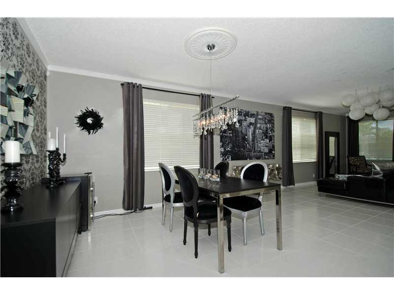 10096 Country Brook Road Boca Raton, FL 33428 - Photo 19 of 29 a view of a dining room with furniture and chandelier