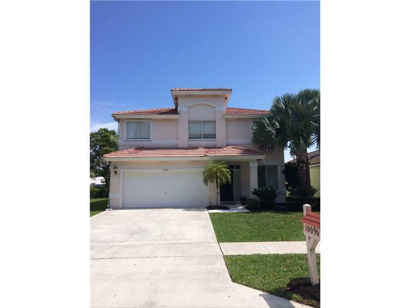 10096 Country Brook Road Boca Raton, FL 33428 - Photo 2 of 29 a front view of a house with a yard