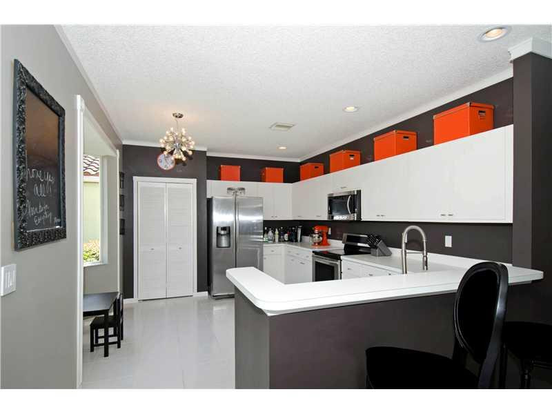 10096 Country Brook Road Boca Raton, FL 33428 - Photo 22 of 29 a kitchen with kitchen island granite countertop a sink and cabinets