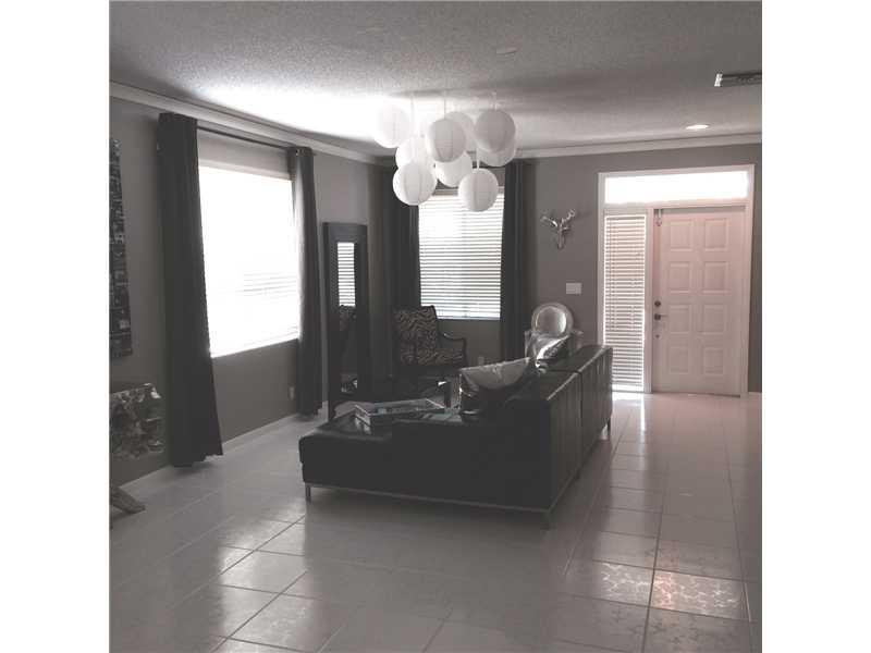 10096 Country Brook Road Boca Raton, FL 33428 - Photo 25 of 29 a living room with furniture and a chandelier