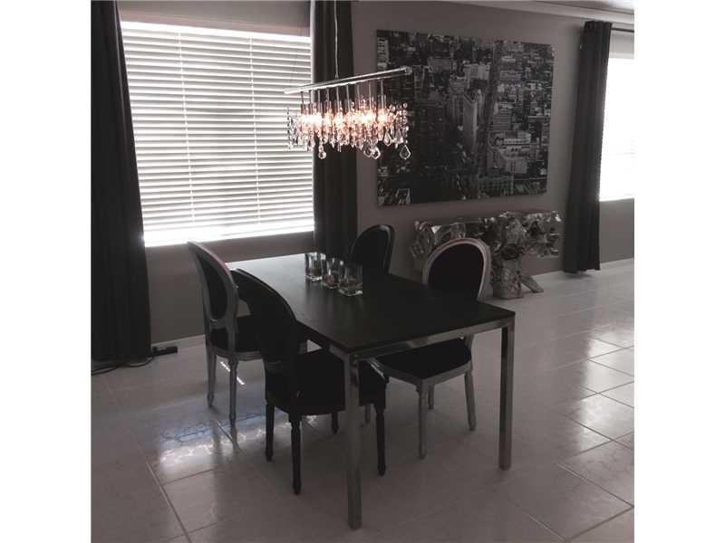 10096 Country Brook Road Boca Raton, FL 33428 - Photo 8 of 29 a view of a dining room with furniture and chandelier