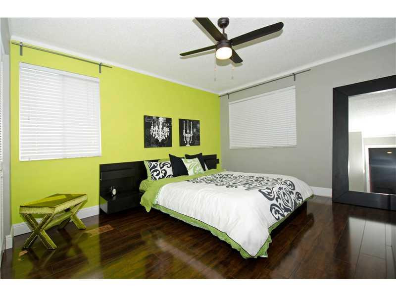10096 Country Brook Road Boca Raton, FL 33428 - Photo 10 of 29 a bedroom with a bed a dresser next to a window