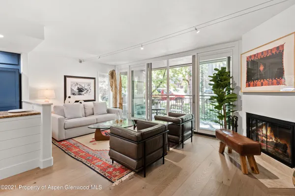 a living room with furniture large window and a fireplace