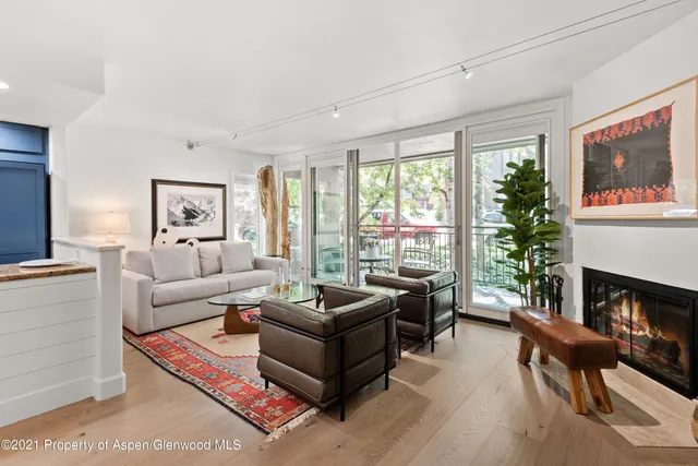a living room with furniture large window and a fireplace