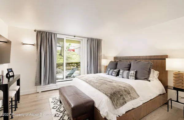 a bedroom with a bed and a large window