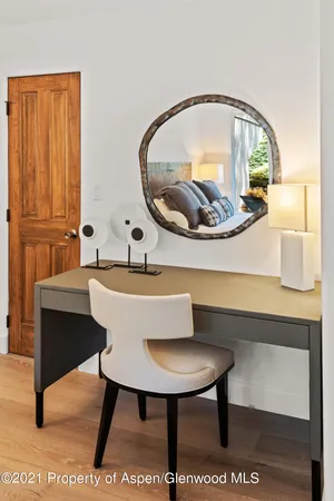 a bathroom with a sink a mirror and a painting on wall