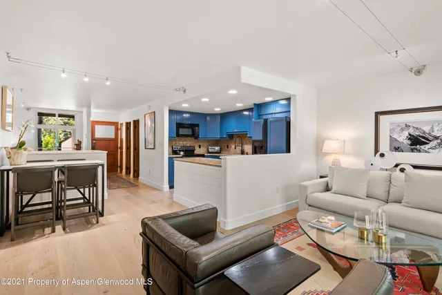 a living room with furniture and kitchen view