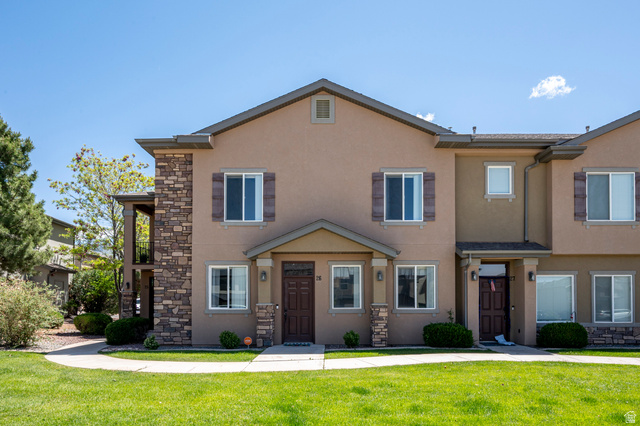 1177 Northfield Road, Unit 26 Cedar City, UT 84721 - Photo 2 of 45 Stucco exterior featuring stone accents, dark wood-finish shutters, and multiple windows