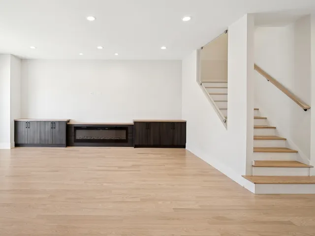 a view of an empty room with stairs and stairs