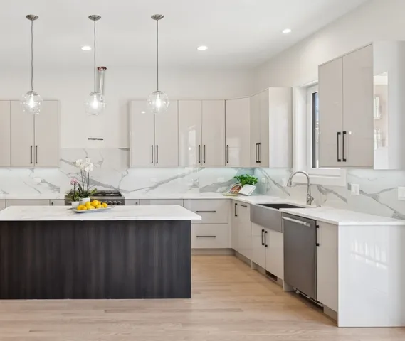 a kitchen with a sink cabinets and wooden floor