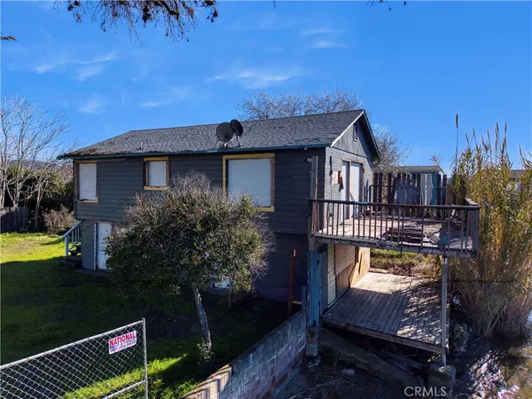 a view of a house with a wooden deck