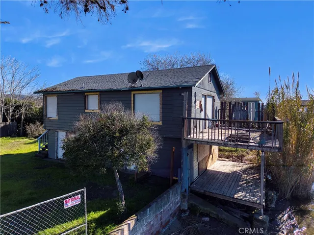a view of a house with a wooden deck
