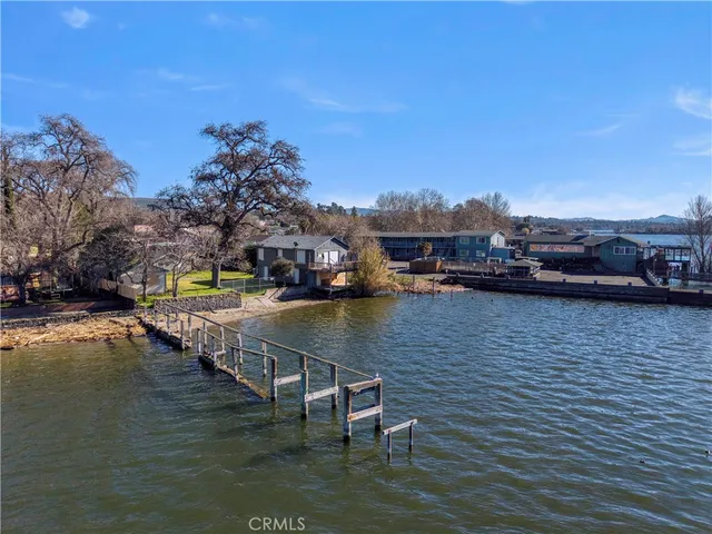 a view of wooden deck and lake from a balcony
